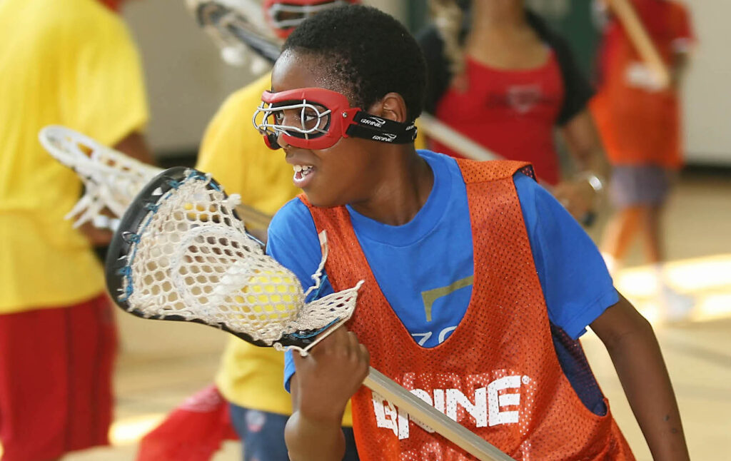 Chris Rossi/For The Examiner
Innocent Okocha, 10, of Silver Spring moves up court during Rosemary Hills Lacrosse practice Friday, August 5, 2005 at Gwendolyn Coffield Community Center in Silver Spring, Md.